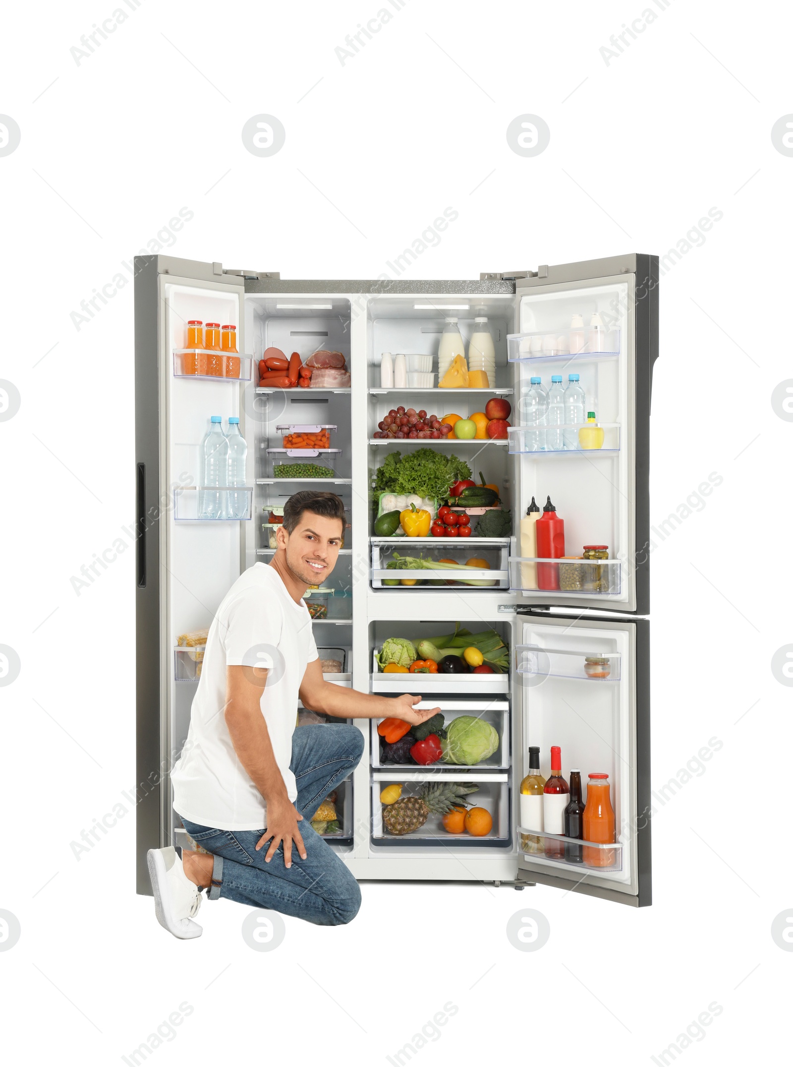 Photo of Man near open refrigerator on white background