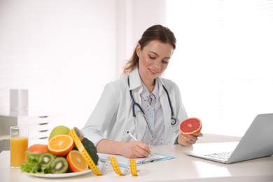 Female nutritionist working at desk in office