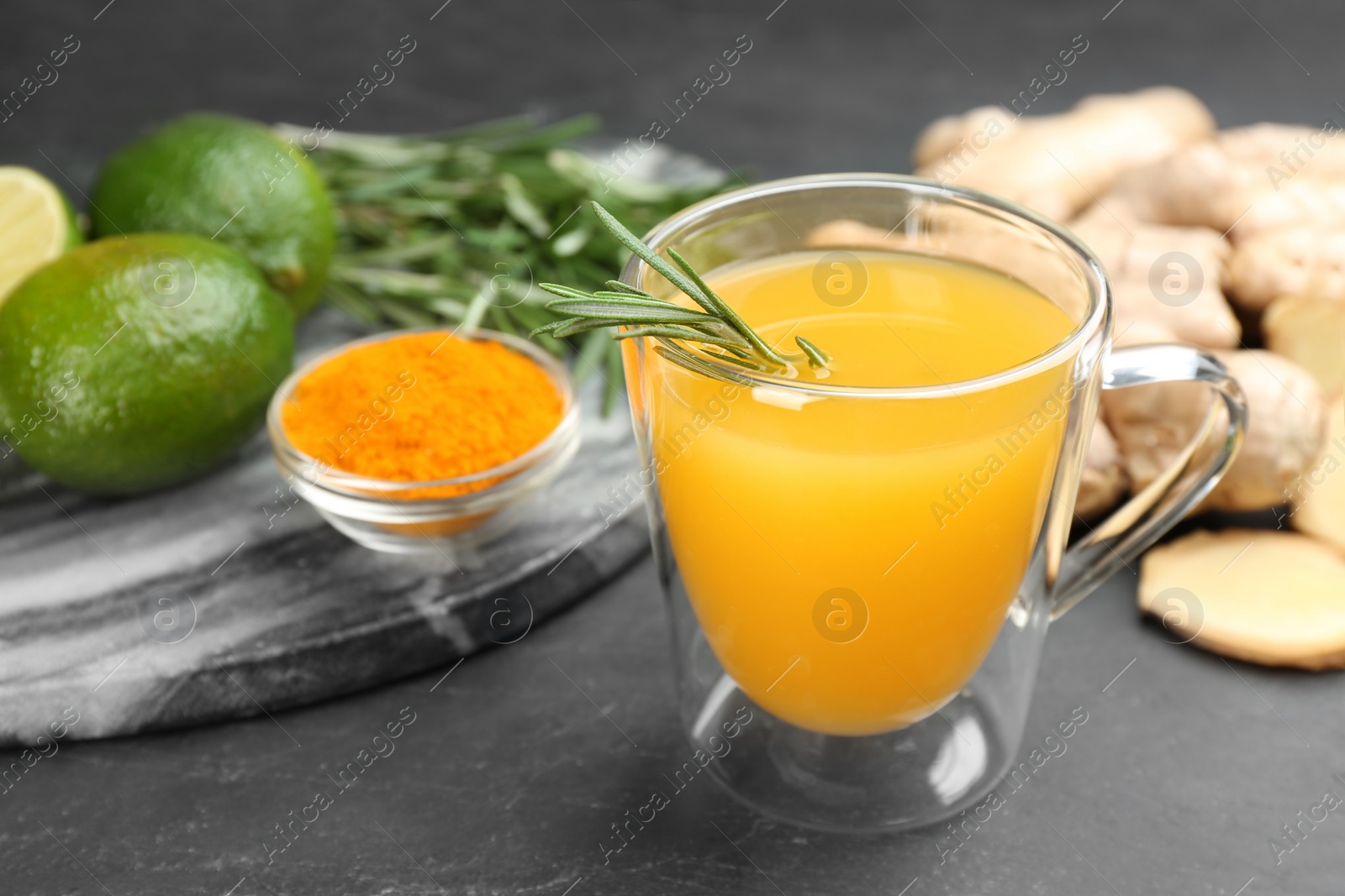 Photo of Immunity boosting drink and ingredients on dark table, closeup