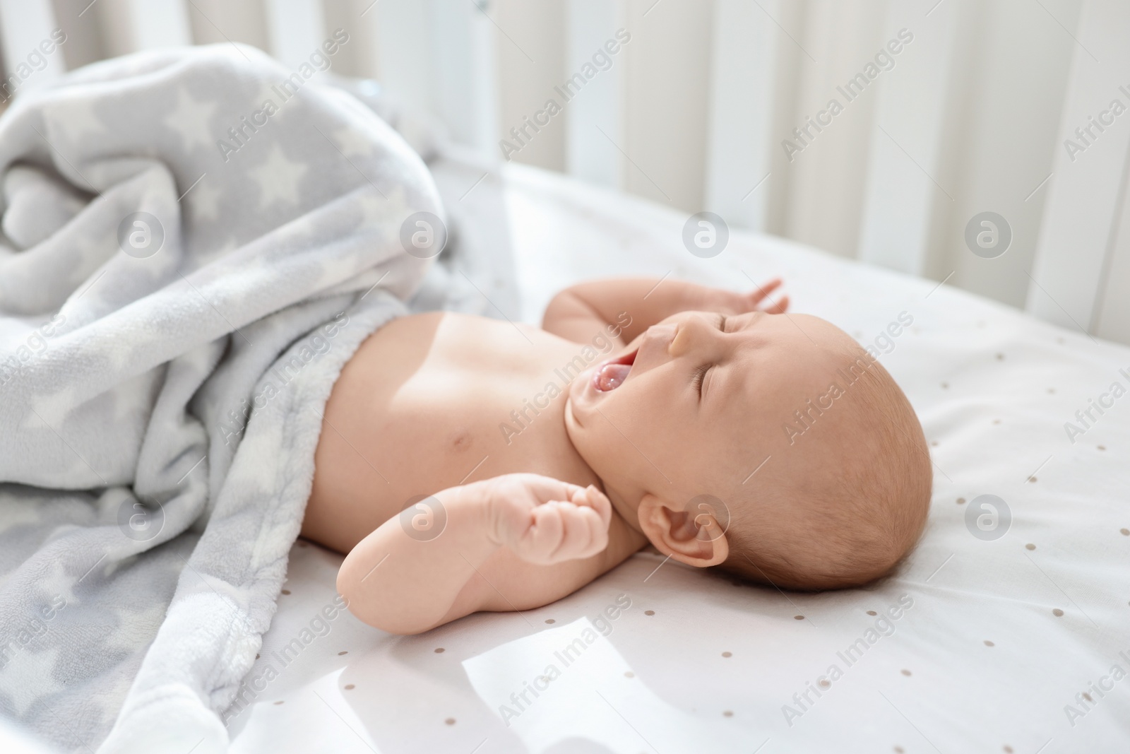 Photo of Cute little baby lying in crib at home