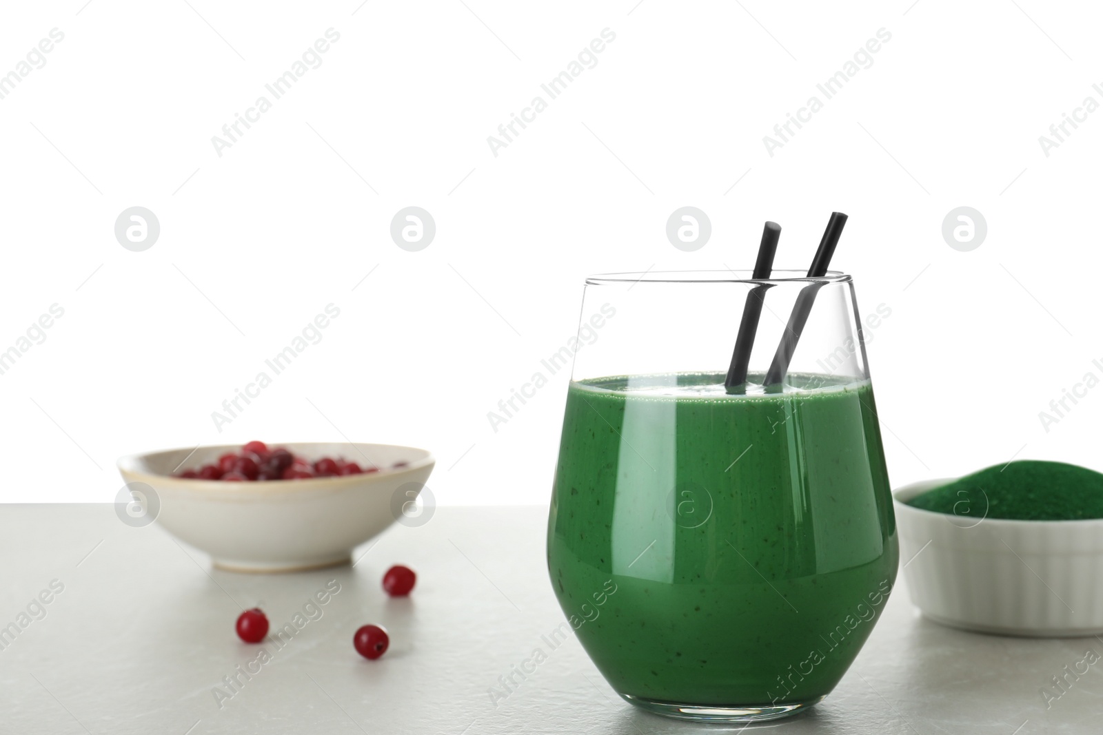 Photo of Composition with glass of spirulina smoothie on table against white background. Space for text