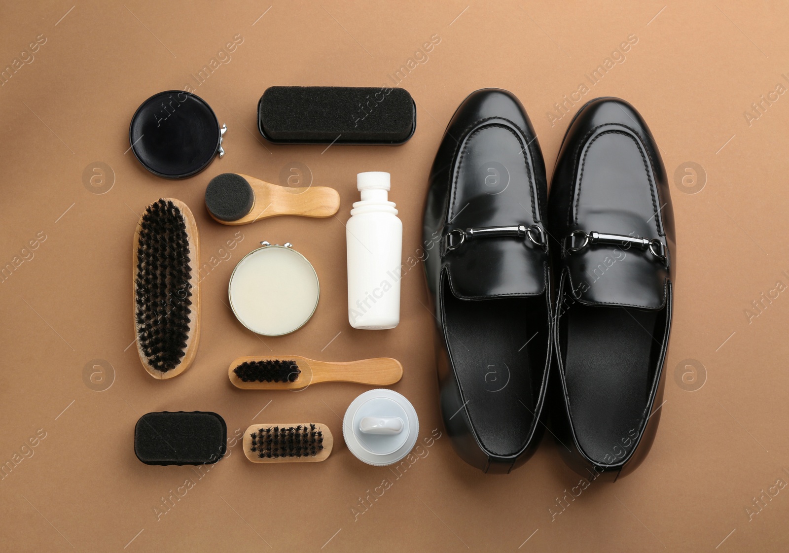 Photo of Flat lay composition with shoe care accessories and footwear on brown background