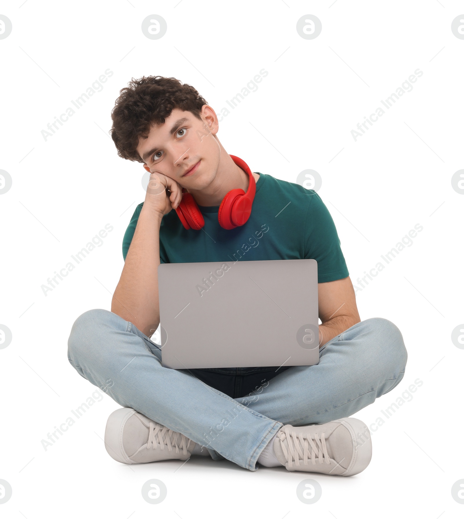 Photo of Portrait of student with laptop and headphones sitting on white background