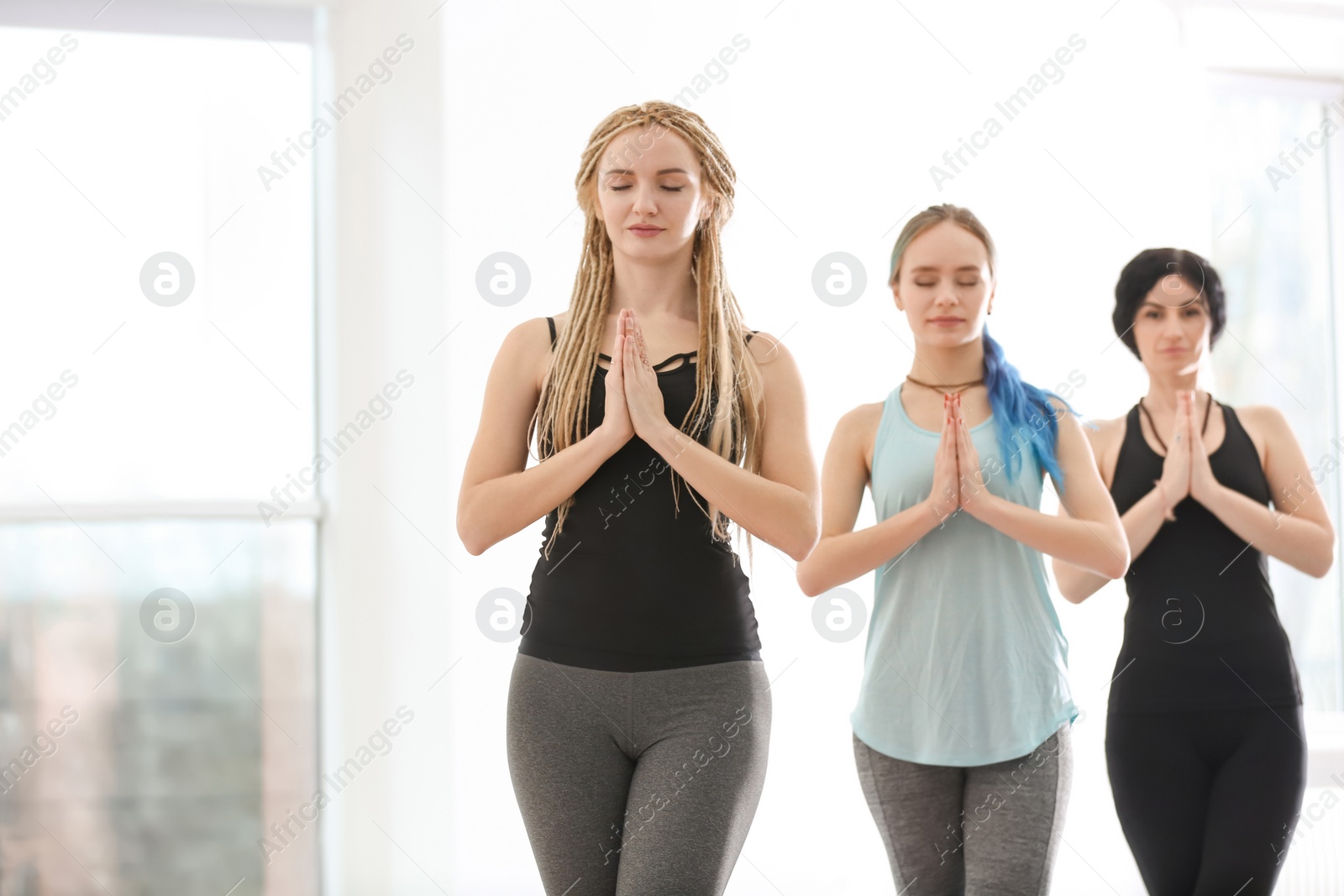 Photo of Group of people practicing yoga indoors