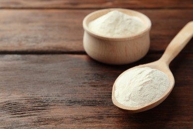 Photo of Bowl and spoon of agar-agar powder on wooden table, closeup. Space for text