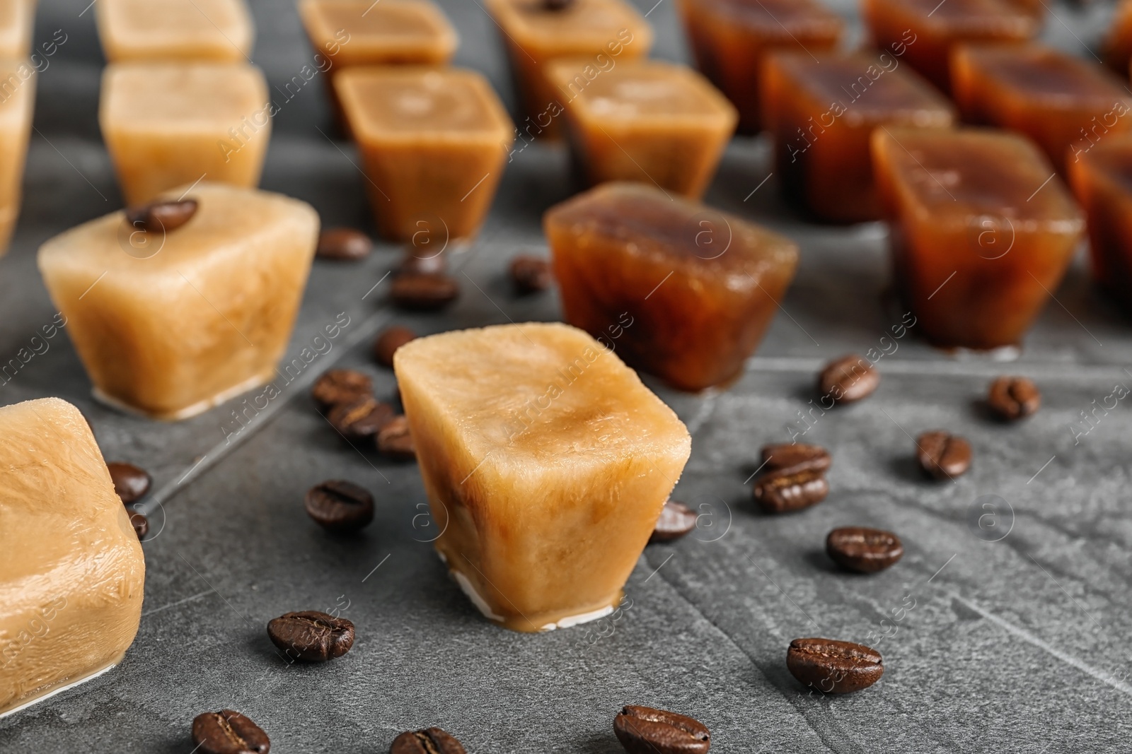 Photo of Composition with coffee ice cubes on grey table