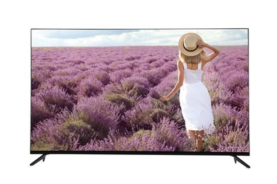 Image of Modern wide screen TV monitor showing woman with bouquet in lavender field isolated on white