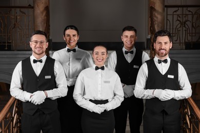 Photo of Group of trainees wearing formal clothes in hotel. Professional butler courses