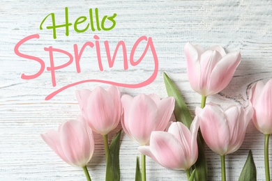 Image of Hello Spring. Beautiful tulips on wooden background, flat lay 