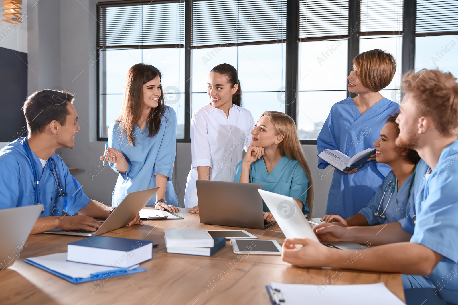 Photo of Group of smart medical students with gadgets in college