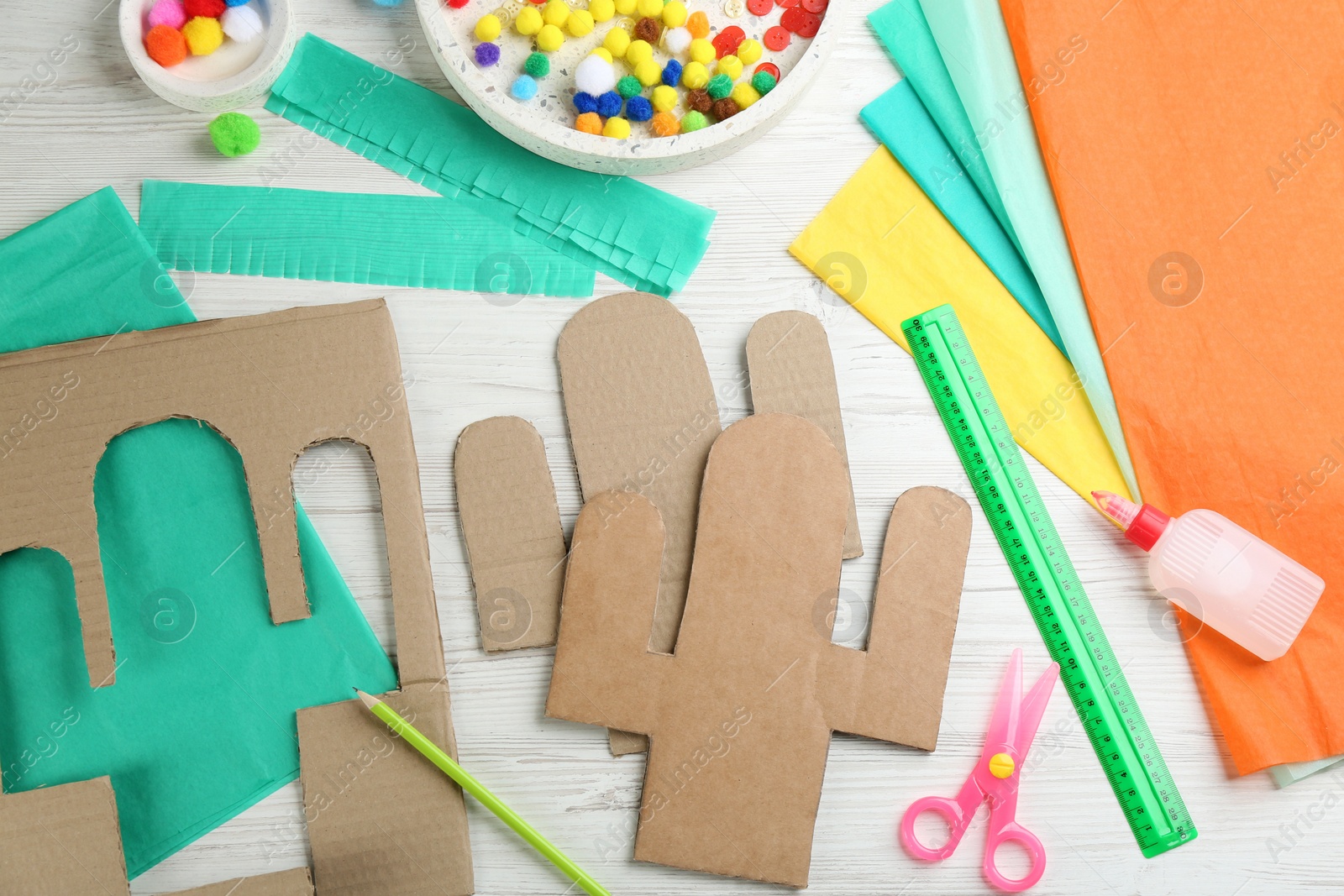 Photo of Materials and tools on white wooden table, flat lay. Cactus pinata DIY