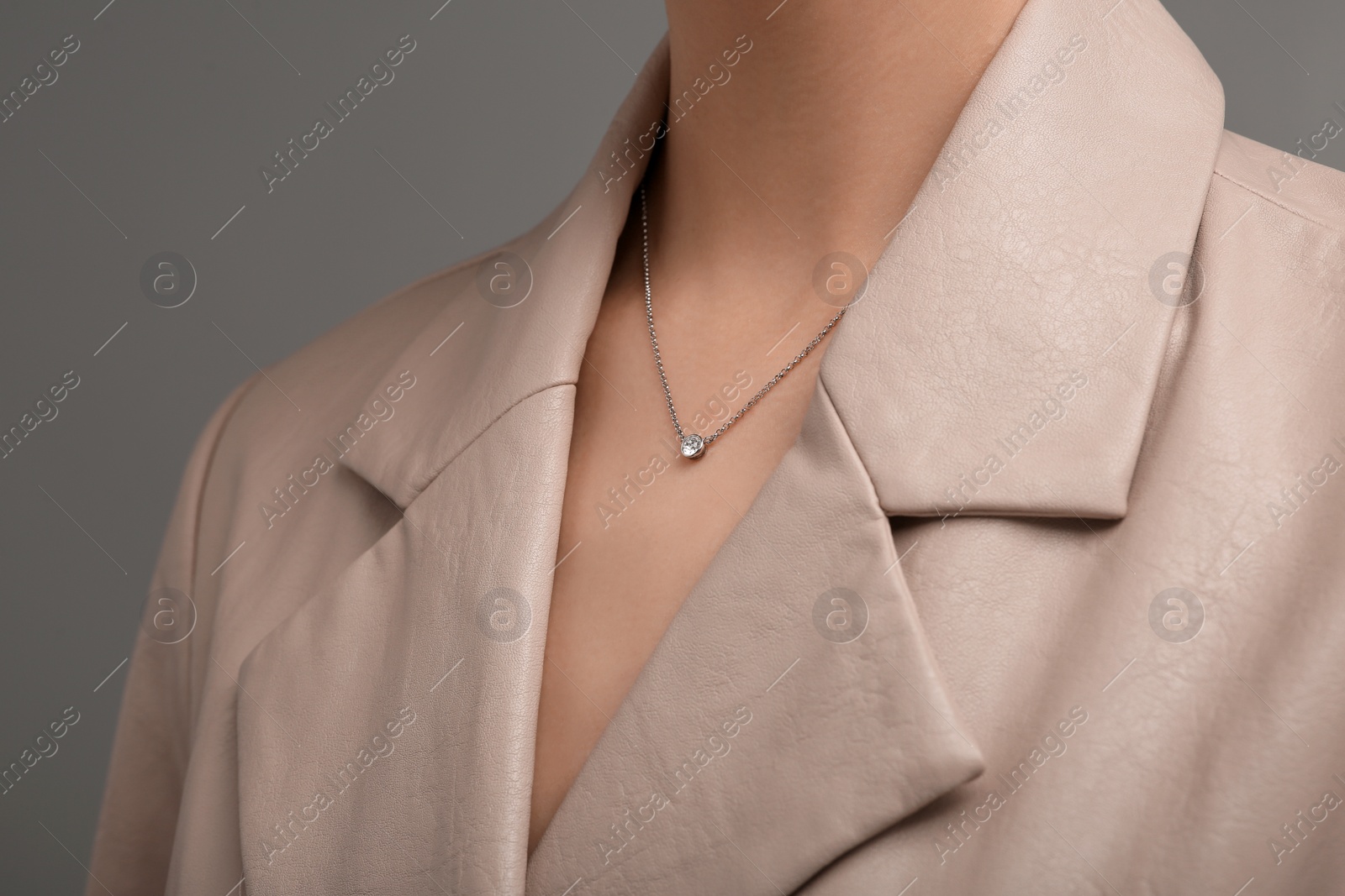 Photo of Woman with elegant necklace on dark grey background, closeup