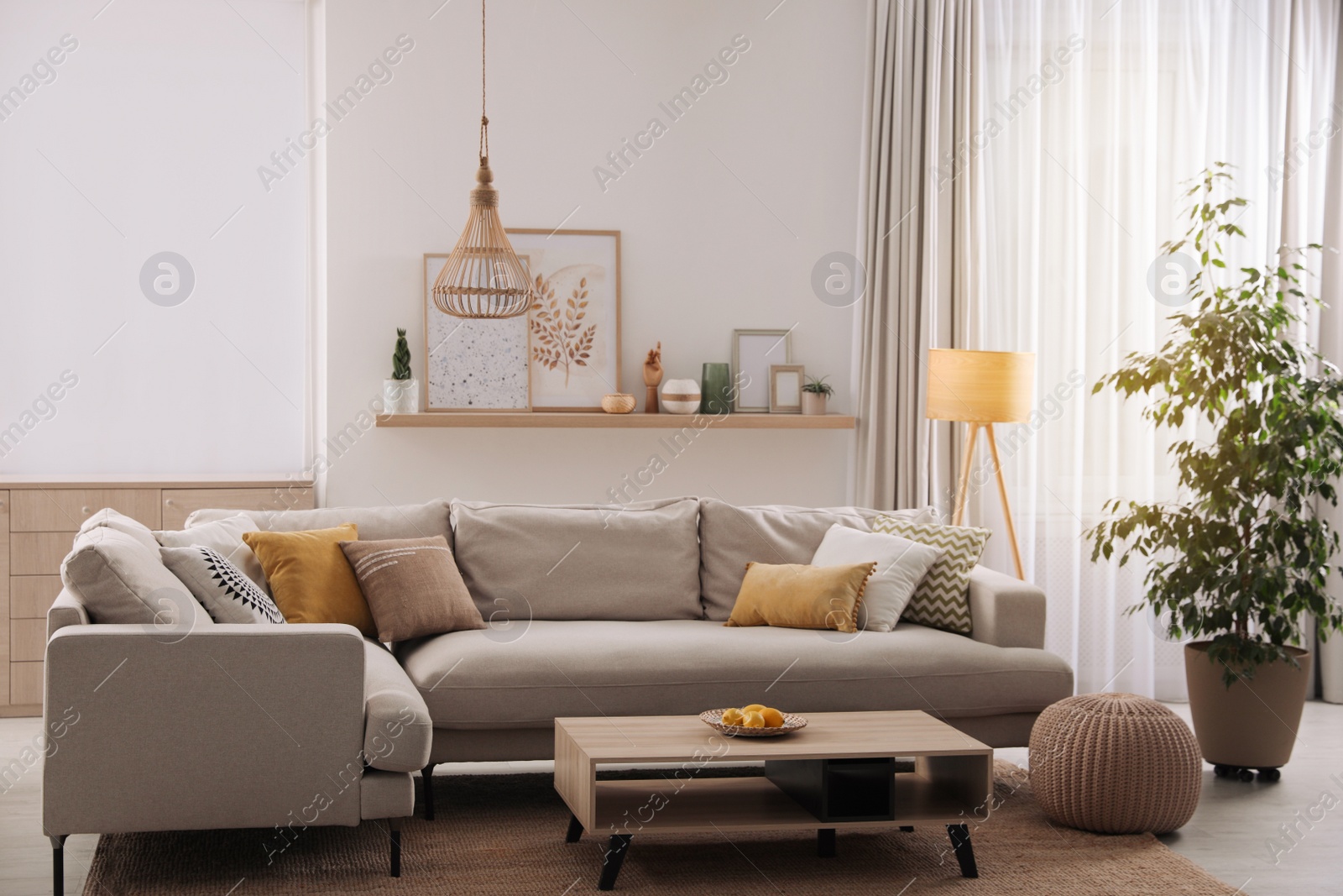 Photo of Stylish living room interior with comfortable grey sofa and coffee table