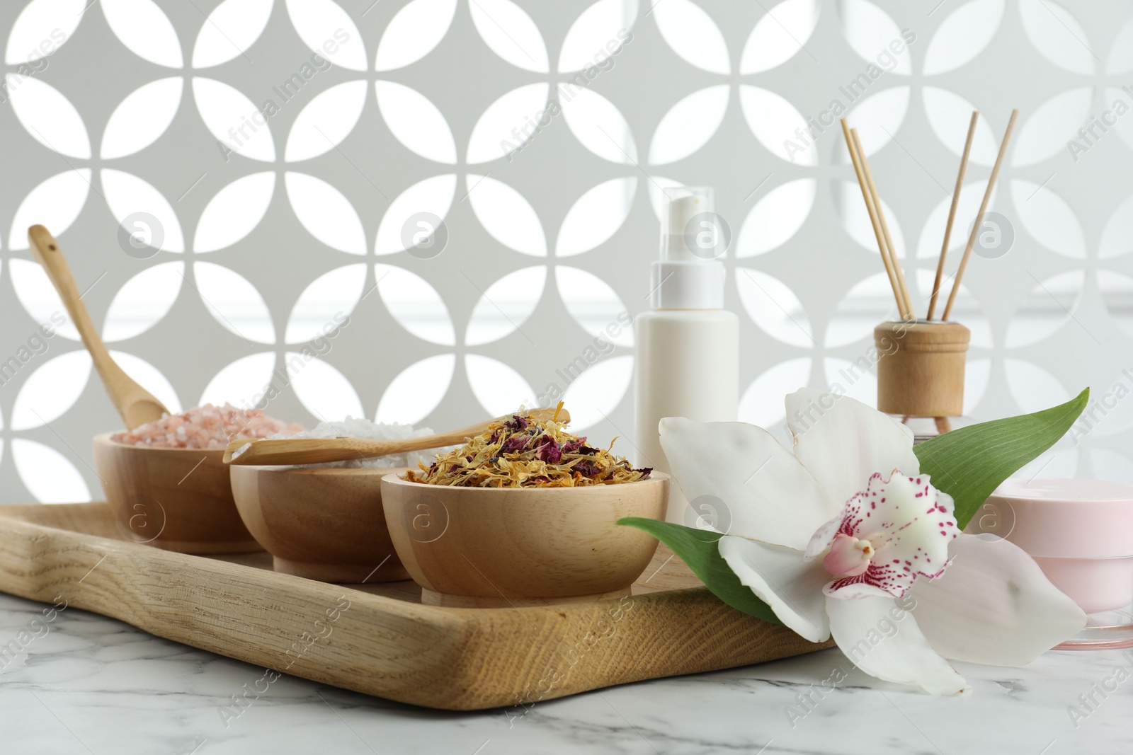 Photo of Beautiful composition with different spa products and orchid on white marble table