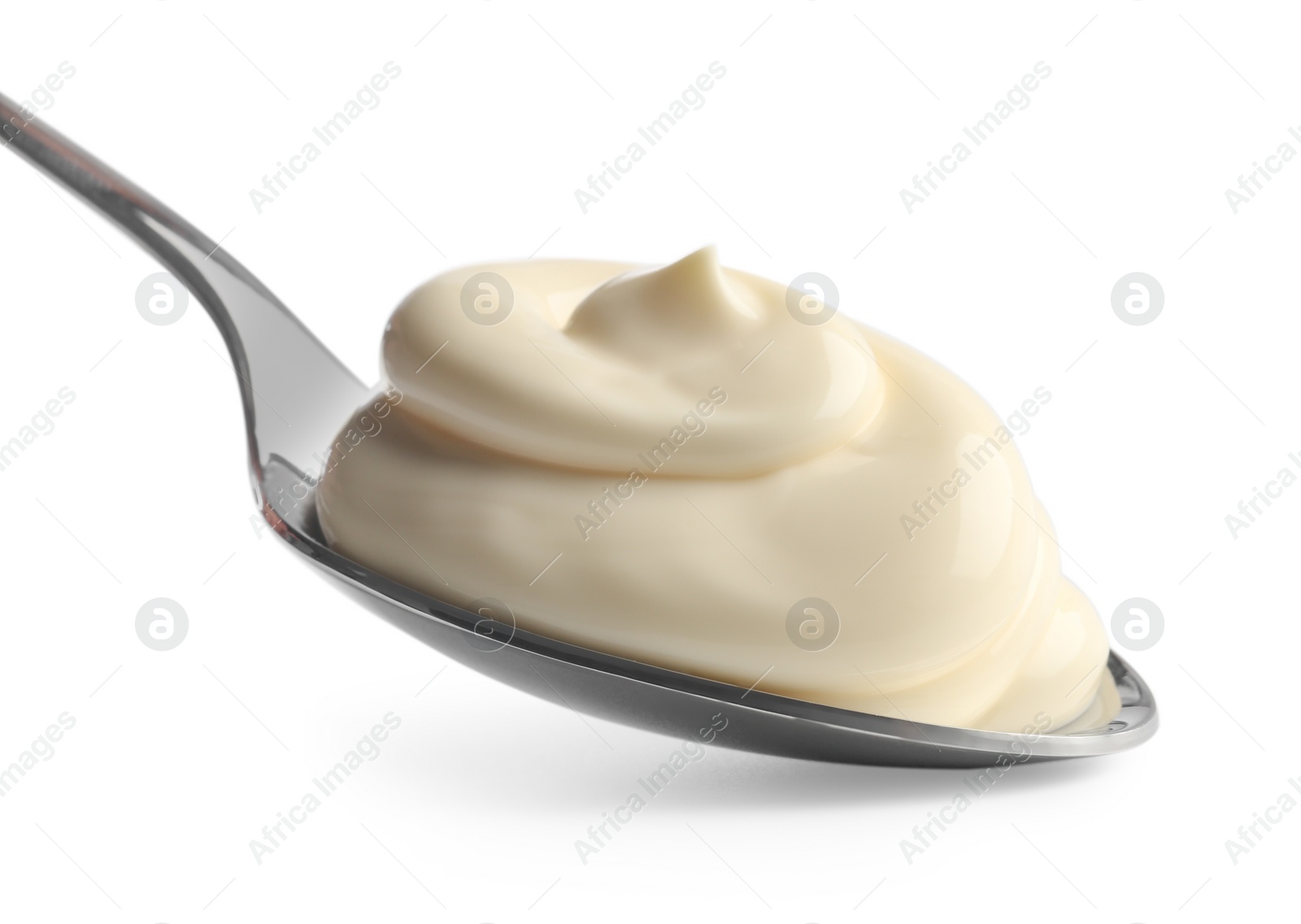 Photo of Natural yogurt in spoon isolated on white