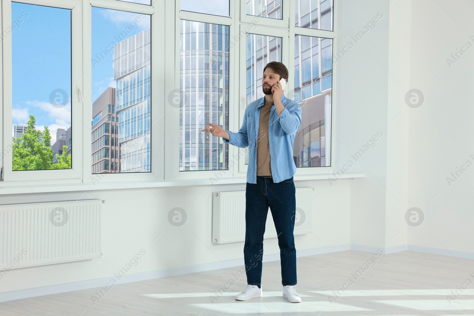 Photo of Man in casual clothes talking on phone indoors