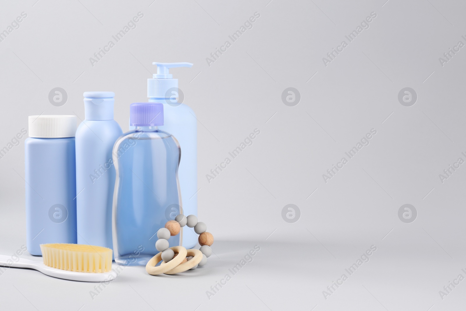 Photo of Different baby care products and accessories on light grey background, space for text