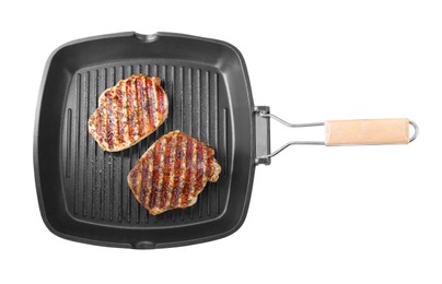 Photo of Grill pan with delicious pork steaks isolated on white, top view