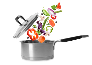 Pot and fresh ingredients for soup on white background