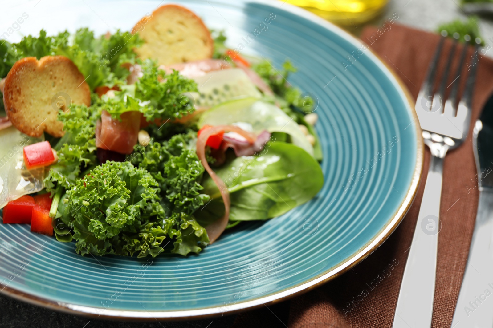 Photo of Delicious salad with kale leaves on table, closeup