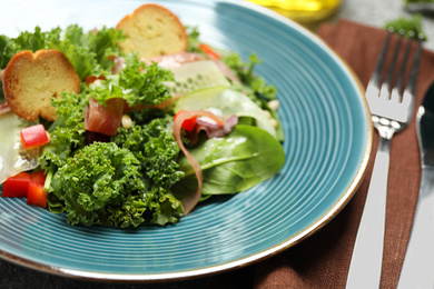 Photo of Delicious salad with kale leaves on table, closeup