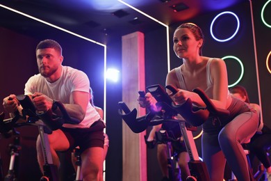 Photo of Group of people training on exercise bikes in fitness club