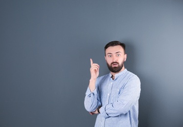 Photo of Portrait of handsome bearded man on color background