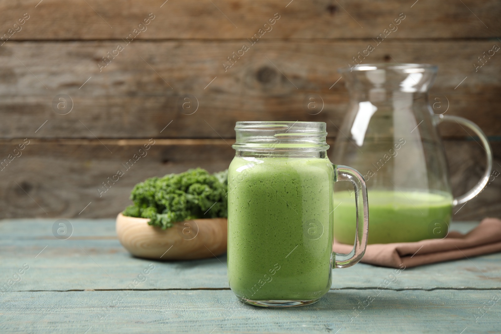 Photo of Tasty fresh kale smoothie on light blue wooden table