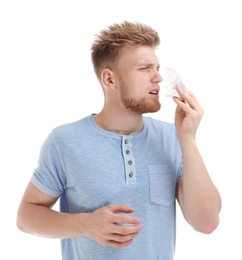 Young man suffering from allergy on white background