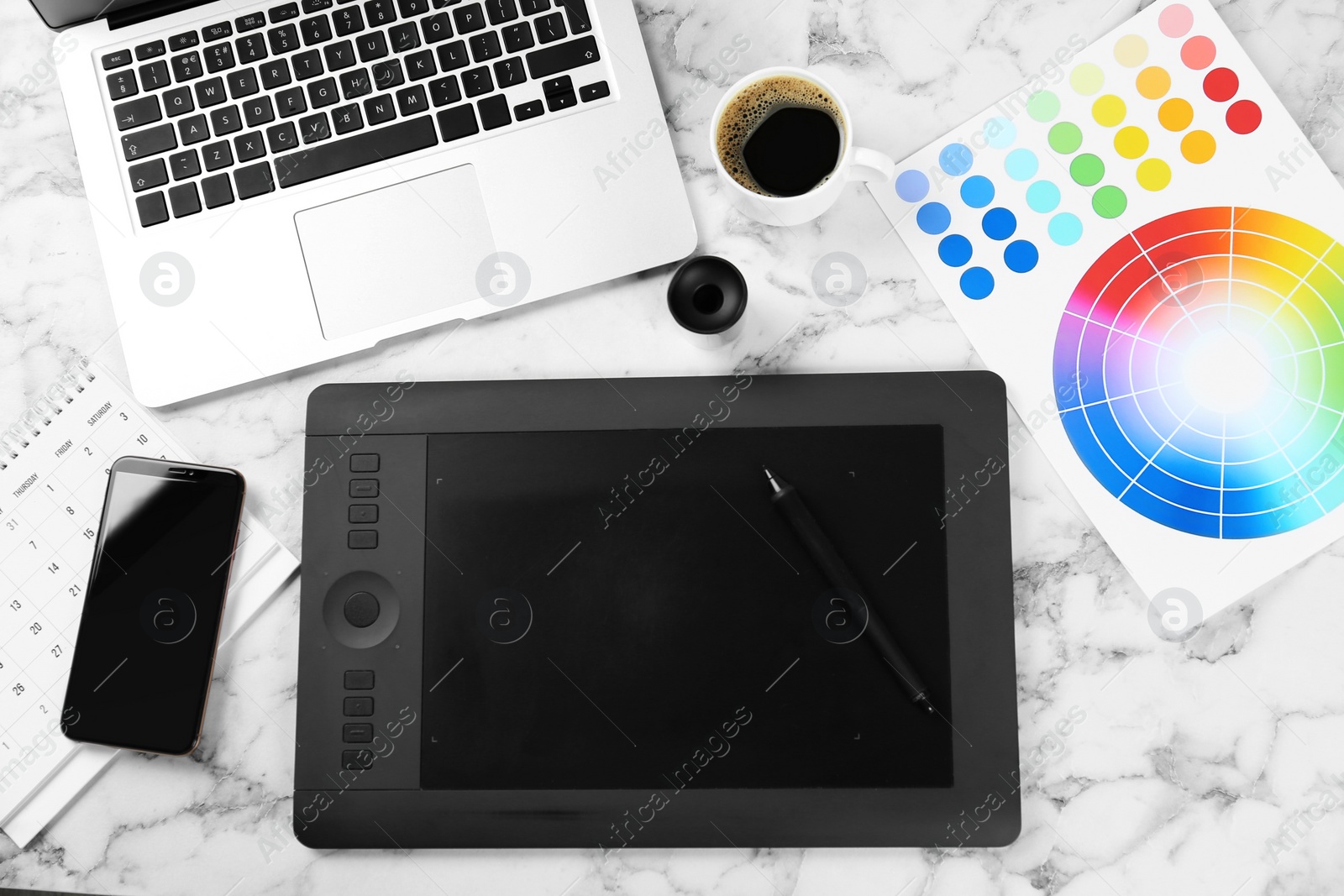 Photo of Flat lay composition with graphic tablet, phone and color palette on white marble table, space for text. Designer's workplace