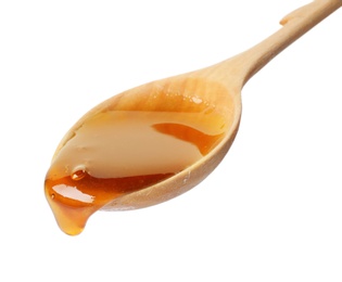 Photo of Honey dripping from spoon on white background