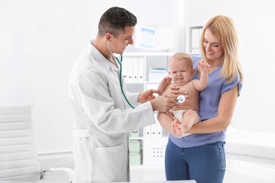 Woman with her baby visiting children's doctor in hospital