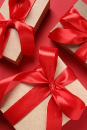 Beautiful gift boxes on red background, flat lay