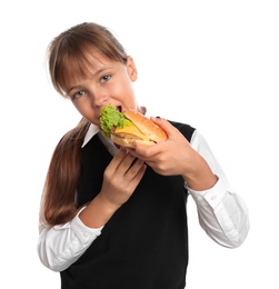 Photo of Little girl eating burger on white background. Healthy food for school lunch