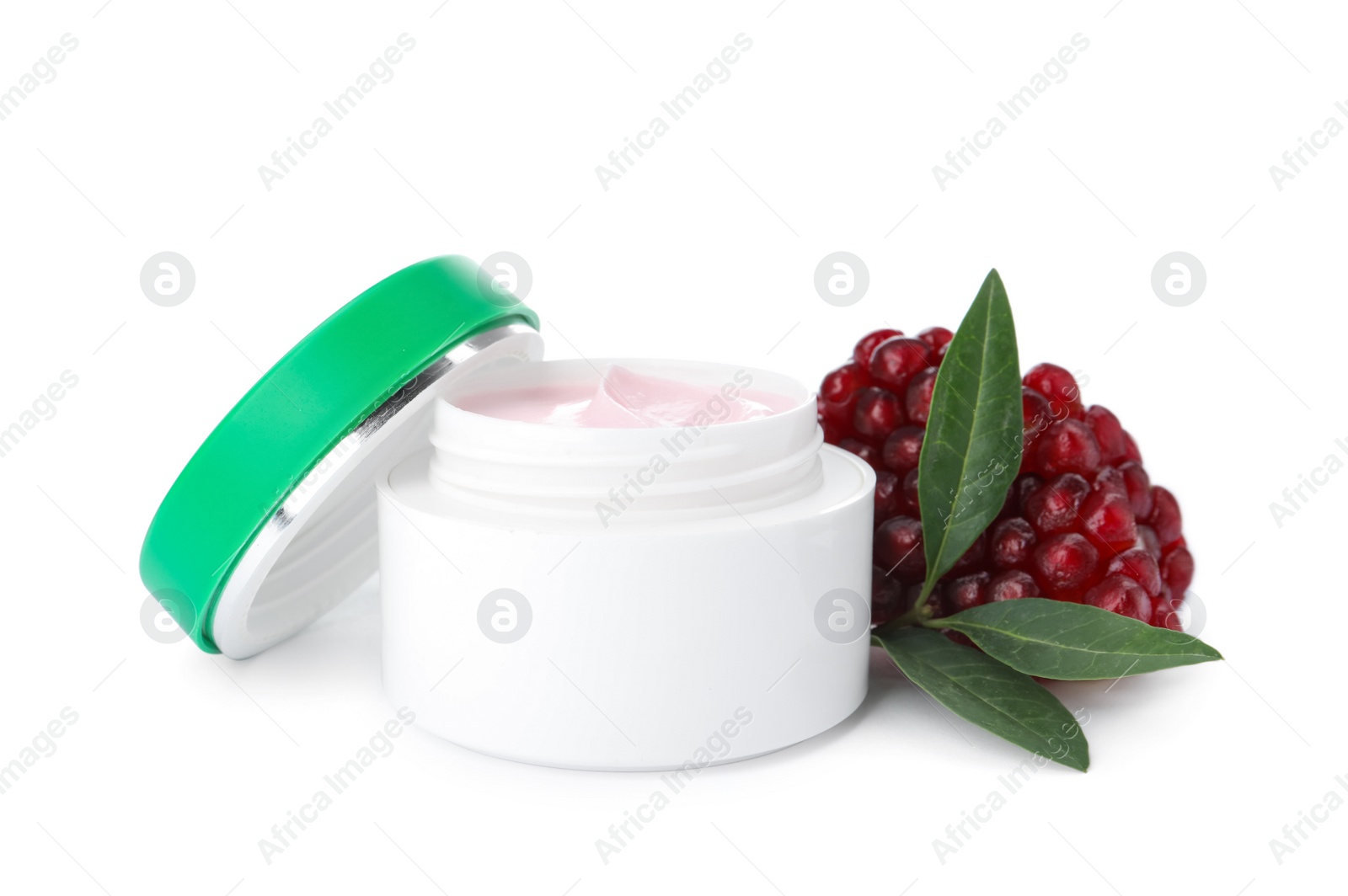 Photo of Jar with natural facial mask, pomegranate seeds and green leaves isolated on white