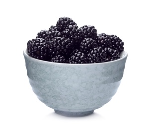 Ceramic bowl of tasty ripe blackberries on white background