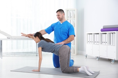 Doctor working with patient in hospital. Rehabilitation exercises