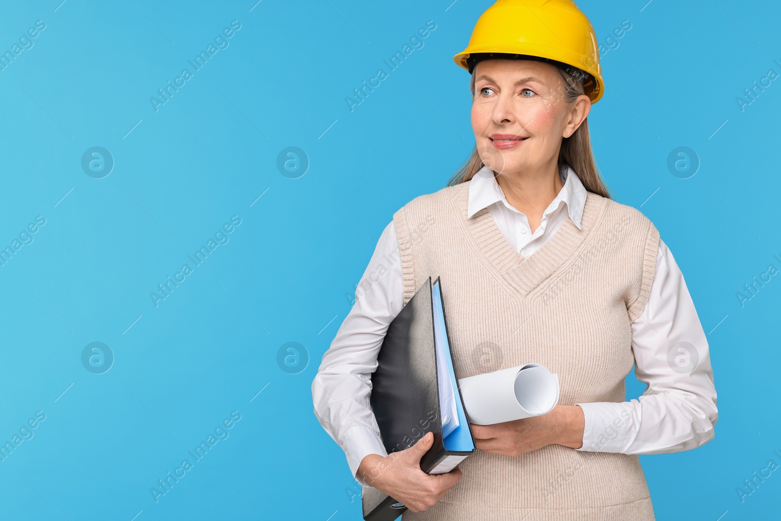 Photo of Architect in hard hat with draft and folder on light blue background, space for text