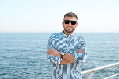 Portrait of handsome young man on sea pier