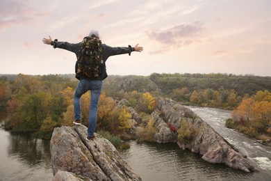 Man enjoying beautiful nature near mountain river, back view