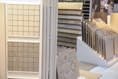 Photo of Assortment of tiles in store. Many different samples indoors