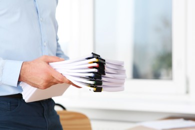 Photo of Businessman with documents in office, closeup. Space for text