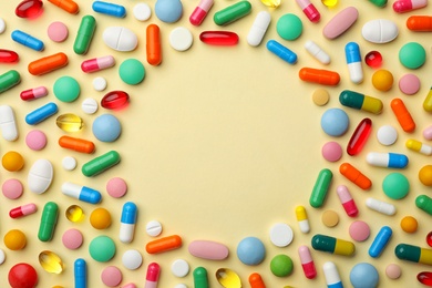 Frame of different pills on color background, flat lay. Space for text