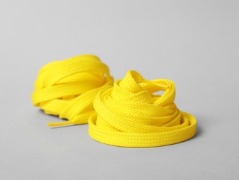 Photo of Yellow shoe laces on light grey background