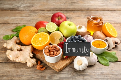 Card with word Immunity and fresh products on wooden table