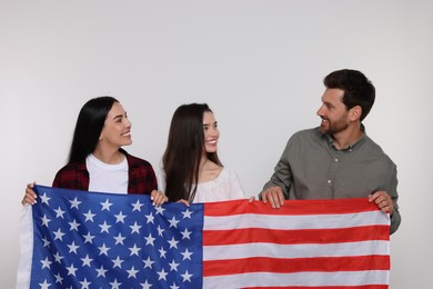 Photo of 4th of July - Independence Day of USA. Happy family with American flag on white background