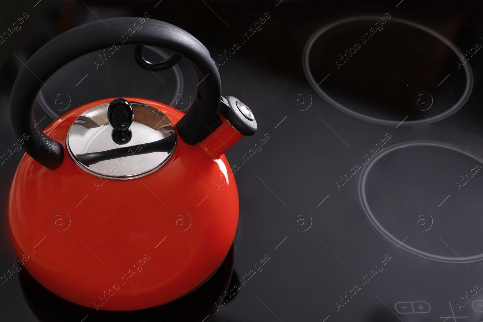 Photo of Modern kettle with whistle on stove, space for text
