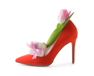 Photo of Stylish lady's shoe with spring tulip and gift box on white background. International Women's Day