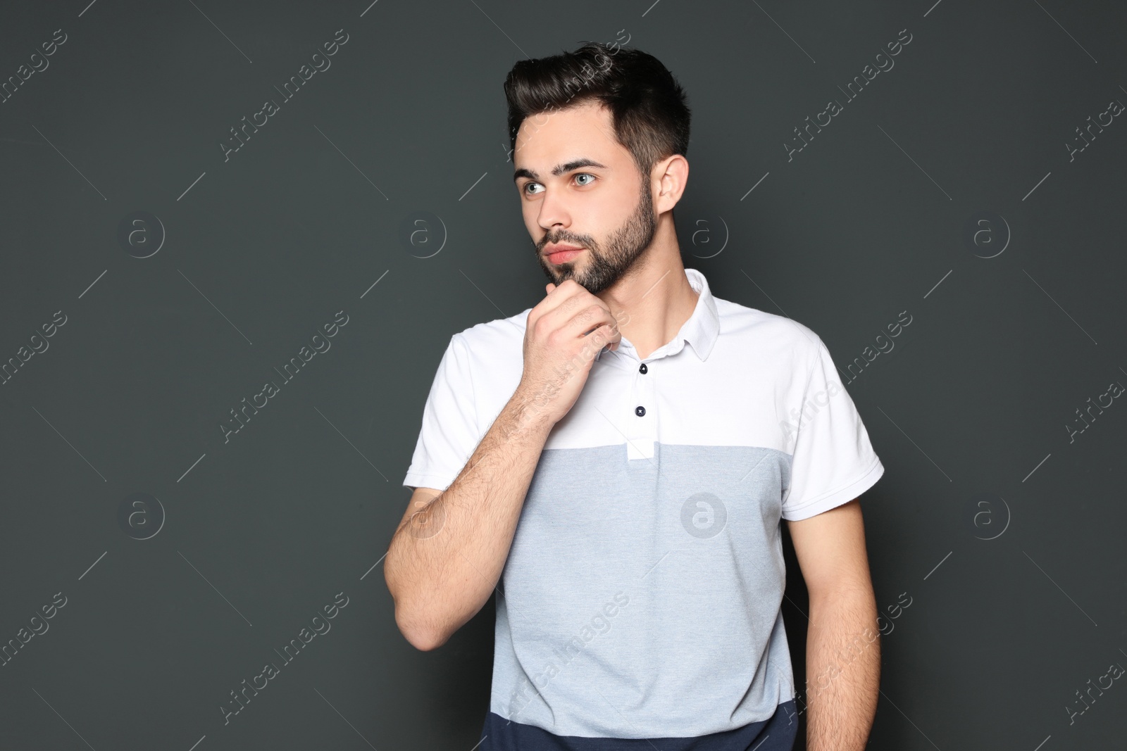 Photo of Portrait of handsome man on grey background