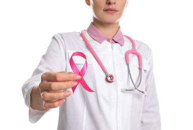 Photo of Doctor with pink ribbon and stethoscope on white background, closeup. Breast cancer awareness